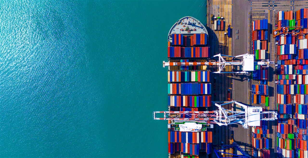 Cargo ship docked at port with shipping containers for Pakistan to Uzbekistan trade planning