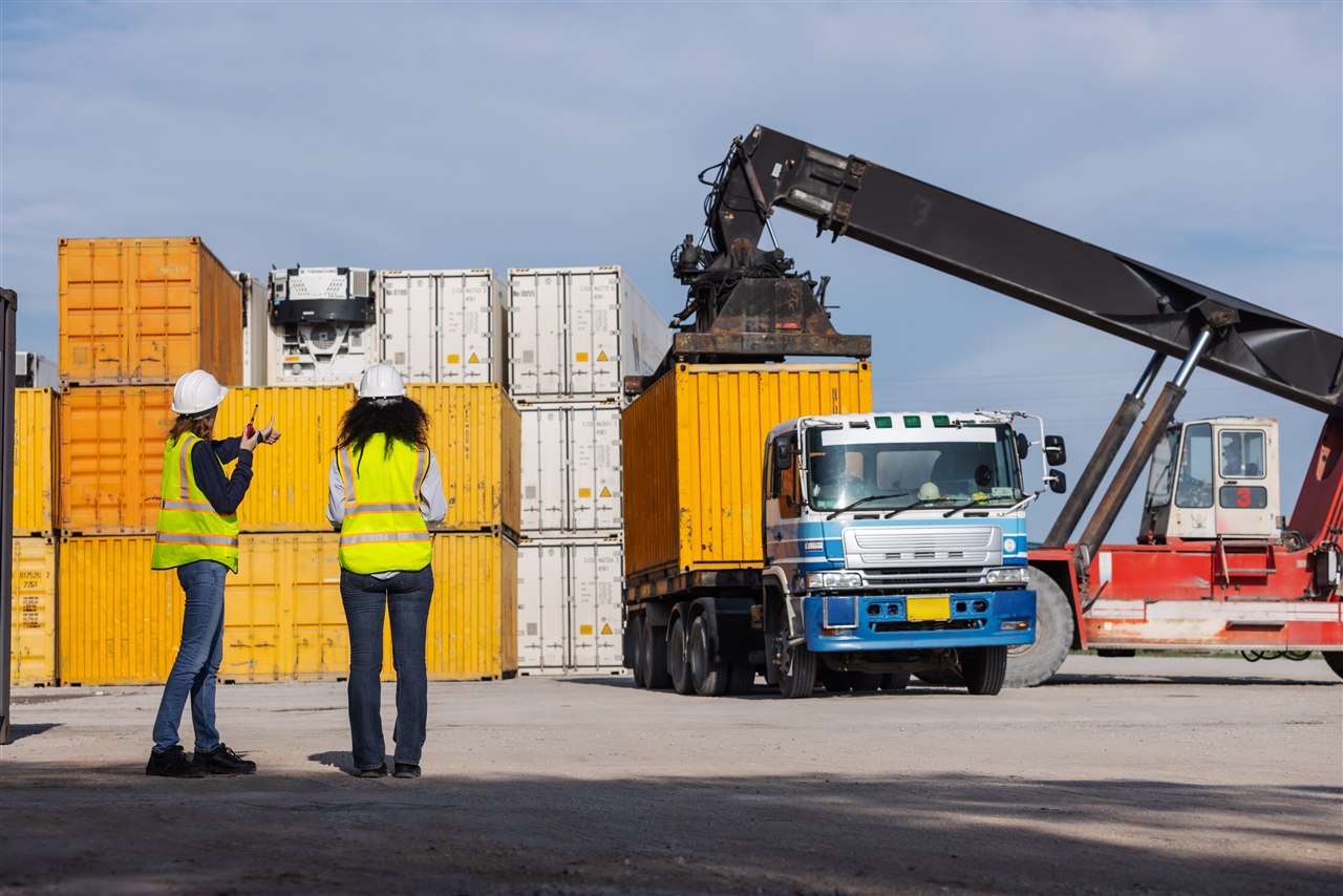 Shipping workers inspecting container loading for cold chain logistics